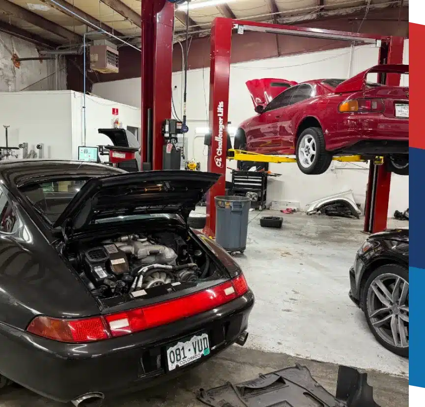 Vehicle We Service In Castle Rock CO At Titan Auto Tech European & Import Auto Repair. A car repair shop with a black Porsche 911 in the foreground and a red Toyota MR2 lifted on a hydraulic car lift in the background, both with their rear hoods open.
